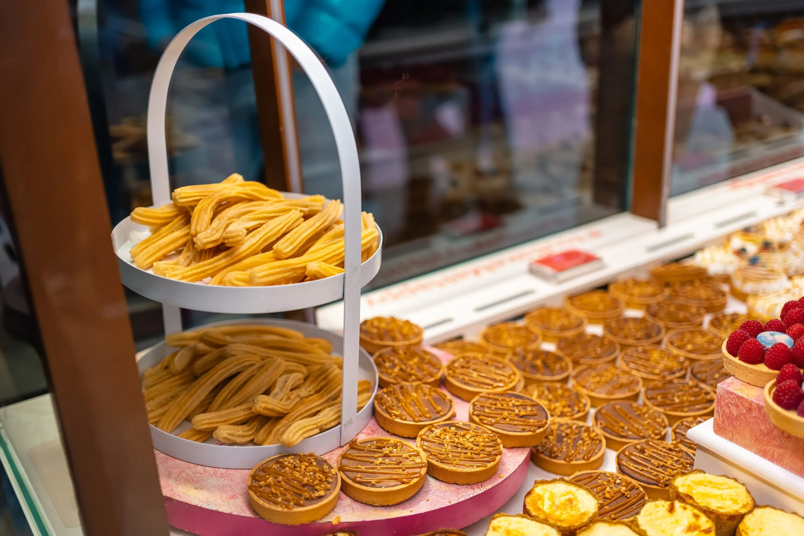 Brazil Dairy Desserts Market Expected to Reach USD 405 Million Driven by Rising Demand for Convenient and Indulgent Treats showcase-with-various-products-breakfast-typical-churros-from-madrid-mercado-de-san-miguel-scaled