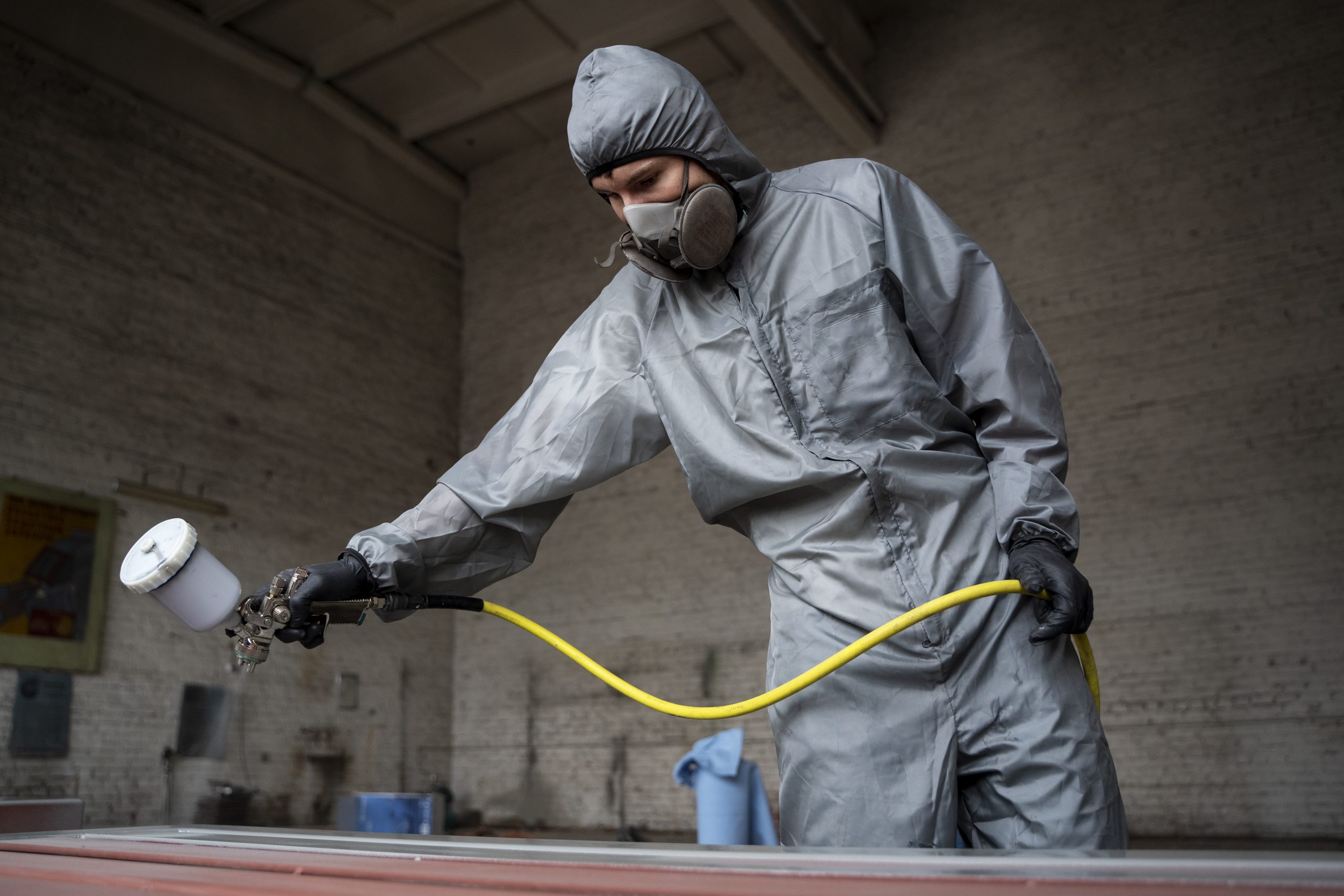 Qatar Powder Coating Market Outlook to 2035 low-angle-worker-spraying-powder-paint-from-gun-scaled