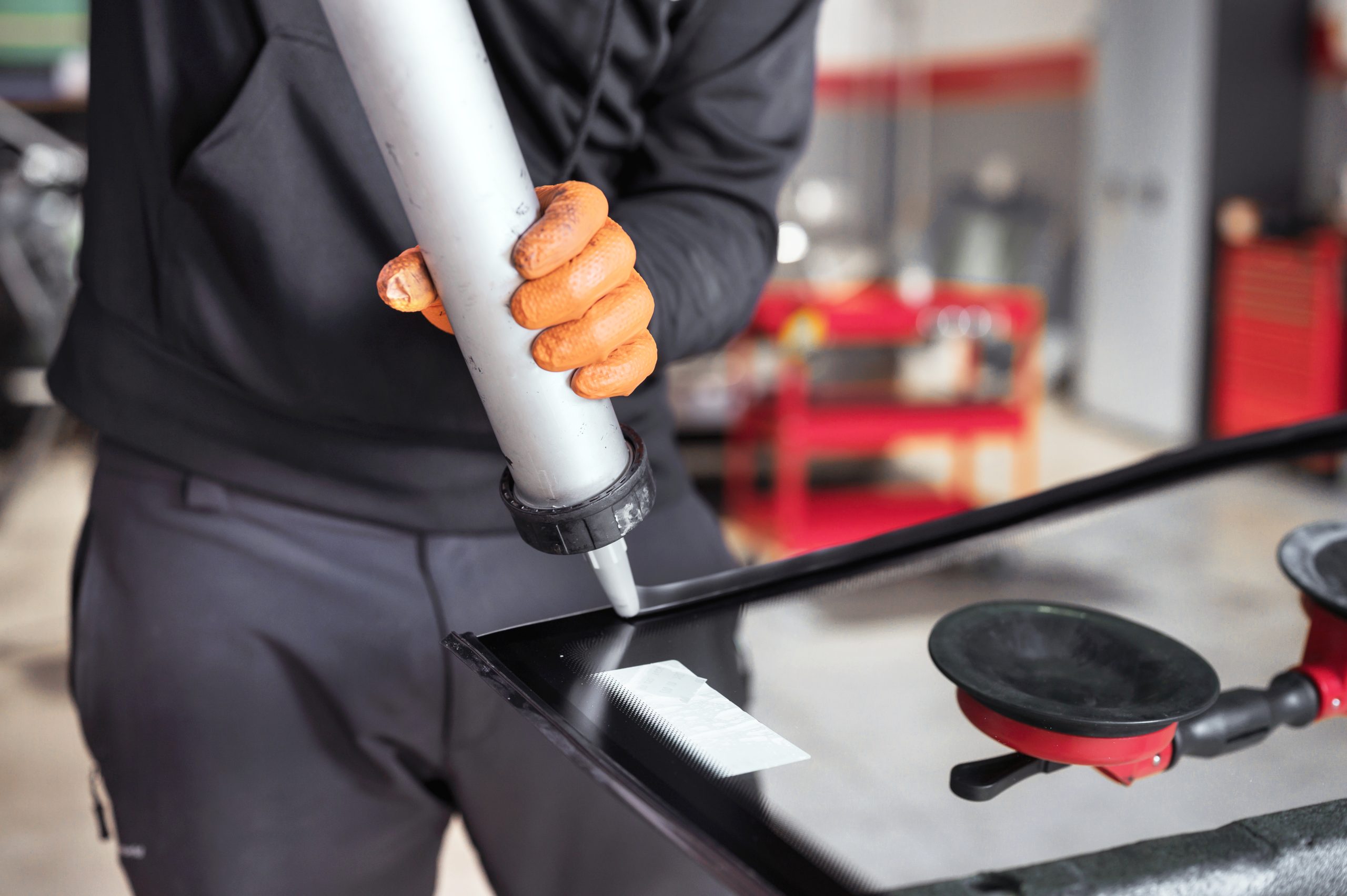 Thailand Polyurethane Sealants Market Outlook to 2035 glazier-applying-rubber-sealing-windshield-garage-close-up-scaled