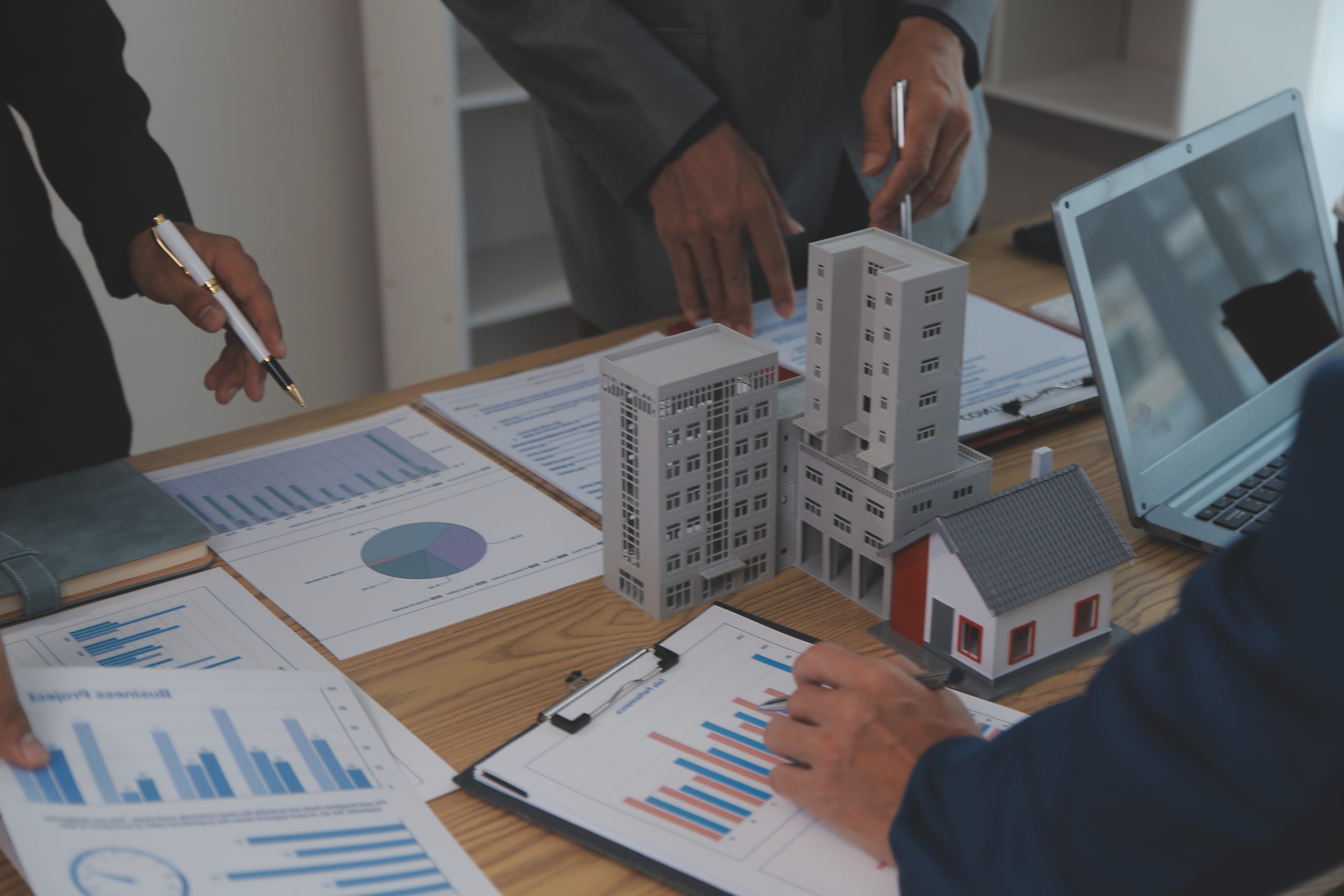 balancing-property-sector-real-estate-agent-is-explaining-house-style-see-house-design-purchase-agreementwooden-house-modern-office-scaled