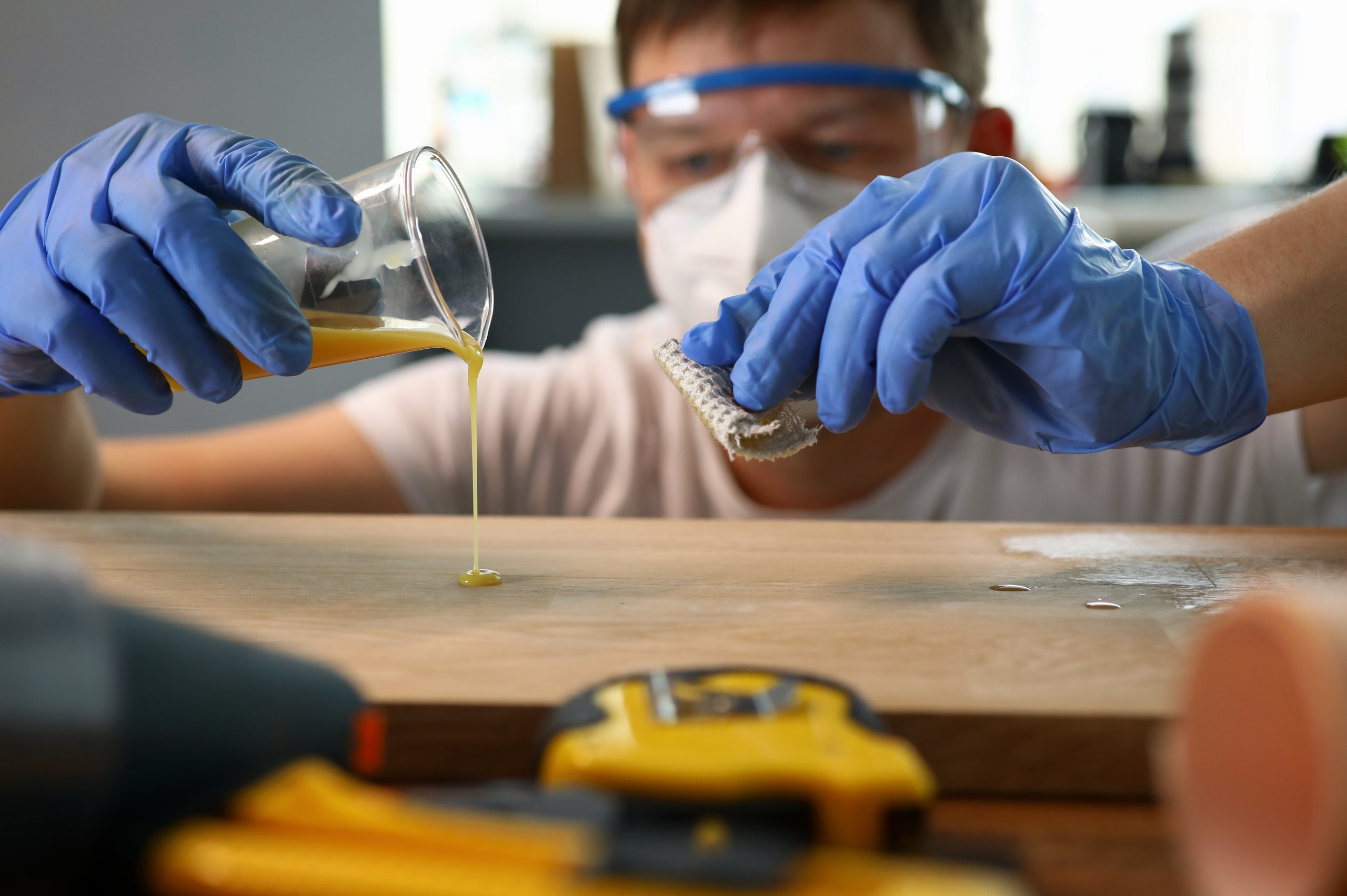 Singapore Repair and Rehabilitation Chemicals Market Outlook to 2035 carpenter-pours-varnish-from-glass-wooden-surface-scaled