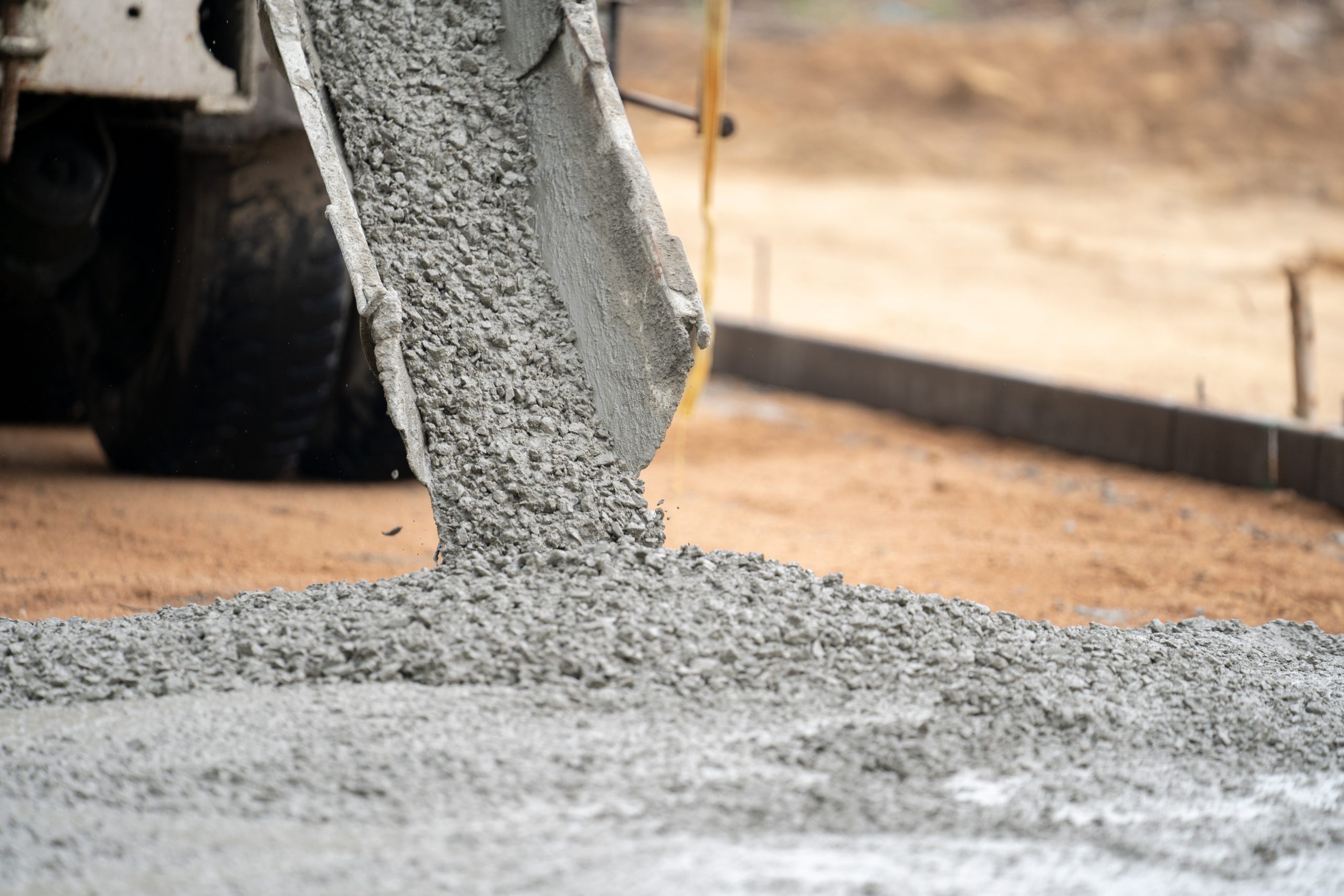 India Concrete Admixtures Market Outlook to 2035 construction-worker-pouring-wet-concret-road-construction-site-scaled