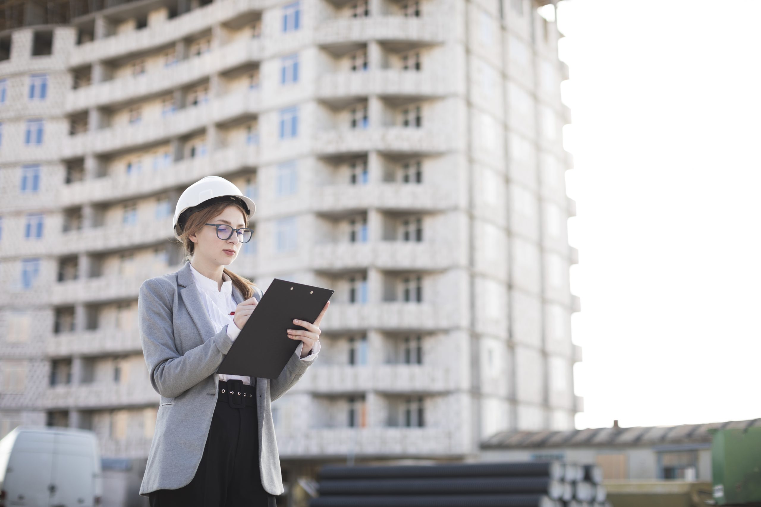 female-architect-writing-clipboard-site-scaled
