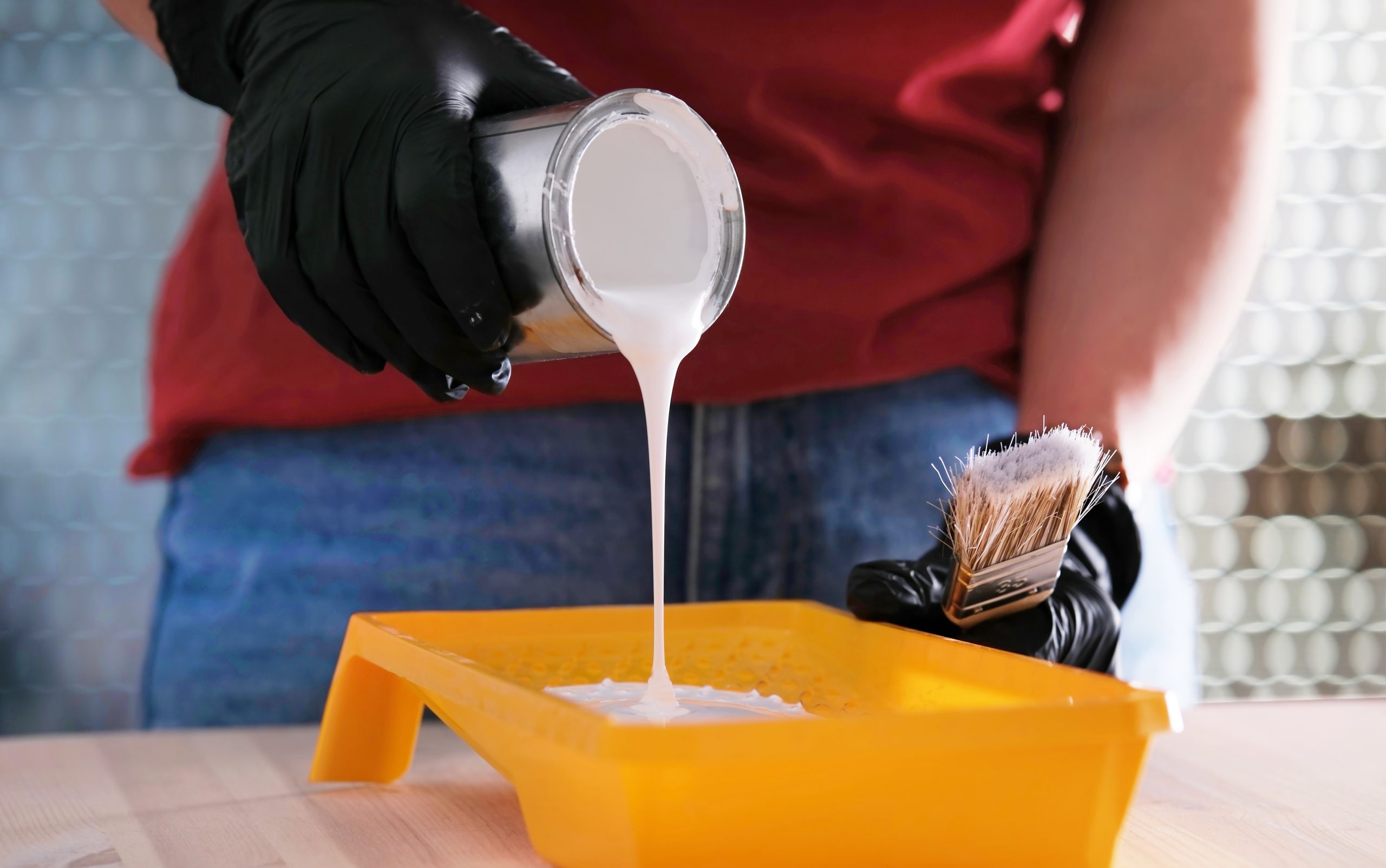 US Construction Adhesives Market Outlook to 2035 girl-pouring-white-paint-into-paint-tray-scaled