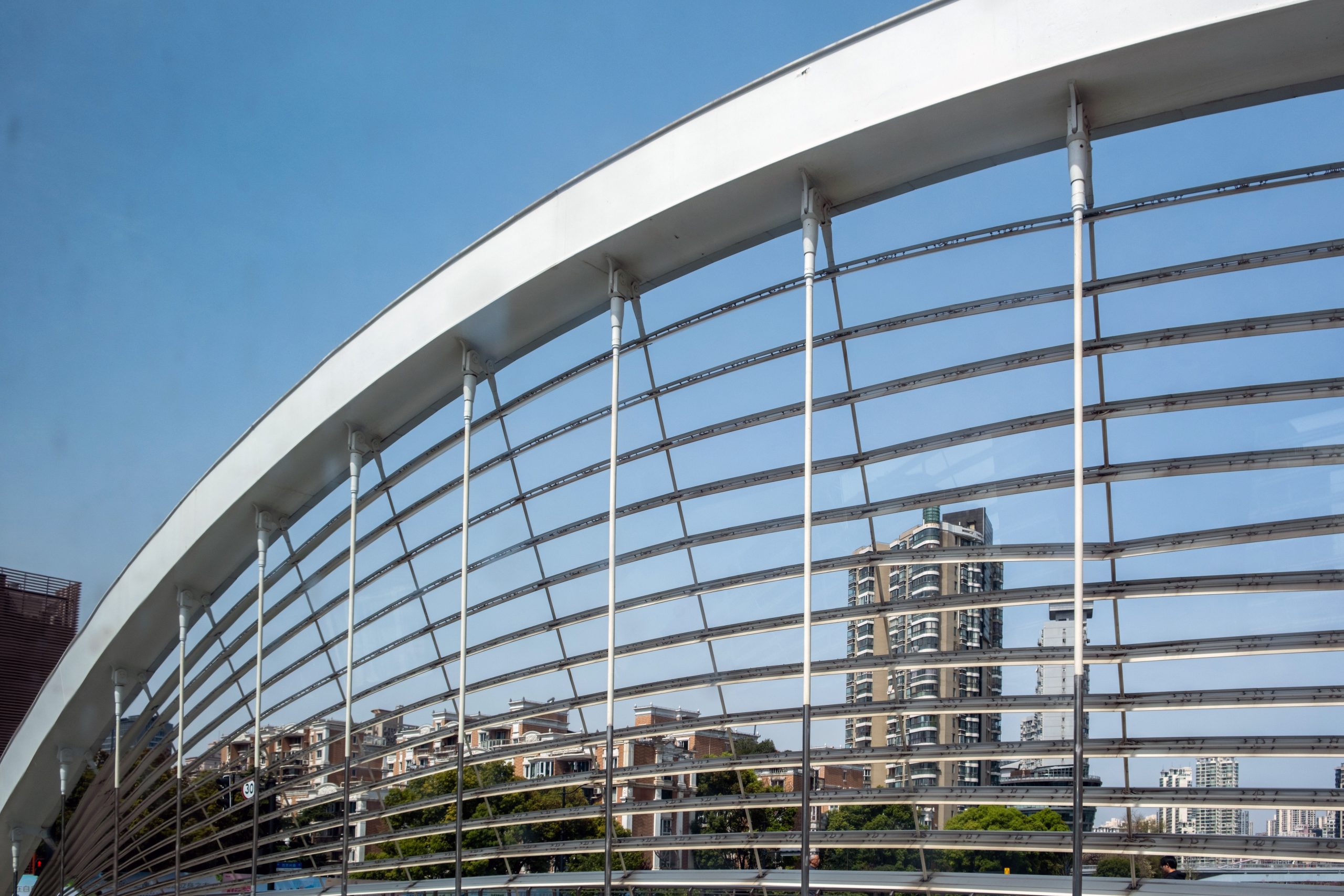 UAE Rainscreen Cladding Market Outlook to 2035 pedestrian-bridge-arch-with-metal-rails-framing-apartment-towers-shanghai-china-scaled