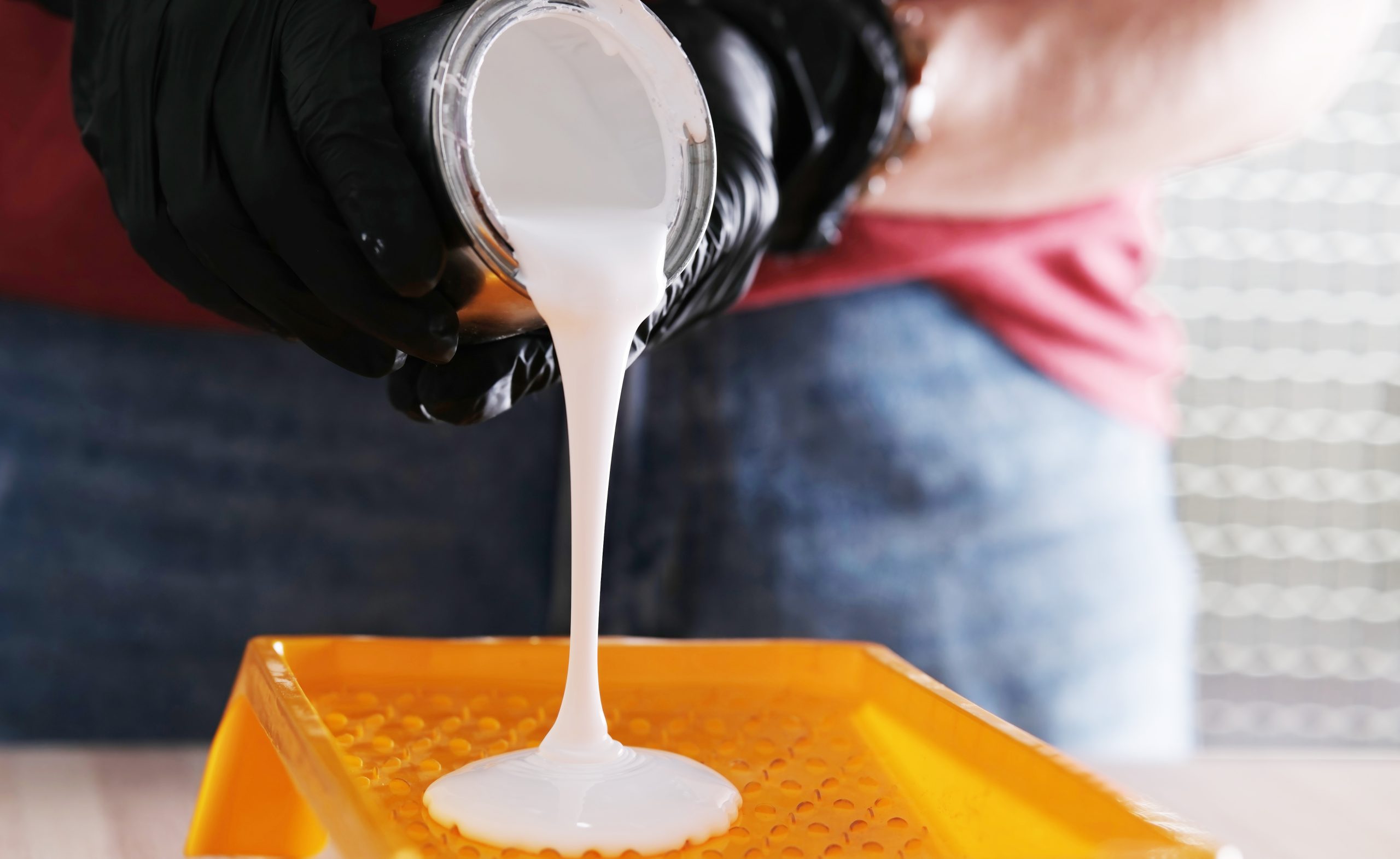 Germany Construction Adhesives Market Outlook to 2035 repairman-pouring-white-paint-into-paint-tray-scaled