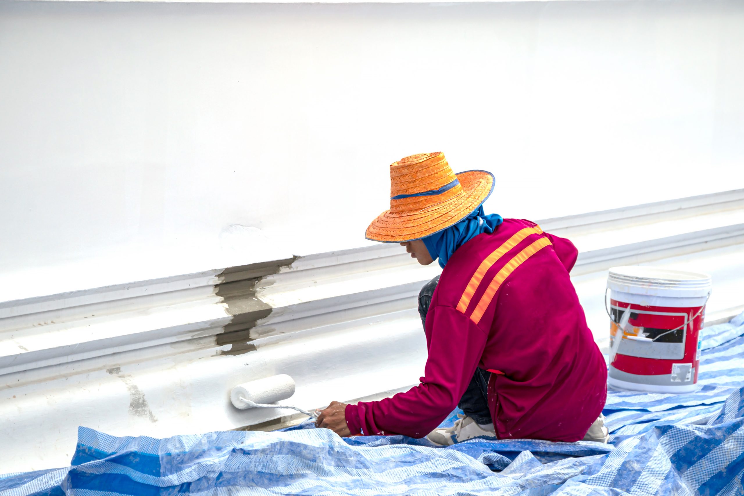 Qatar Cool Roof Coatings and Systems Market Outlook to 2035 worker-painting-white-color-surface-wall-scaled